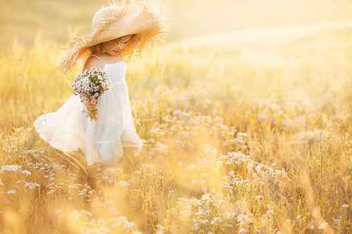 Little girl with a bouquet of wild flowers